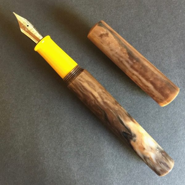 Fountain pen with mix of coffee colours and bright yellow section 2